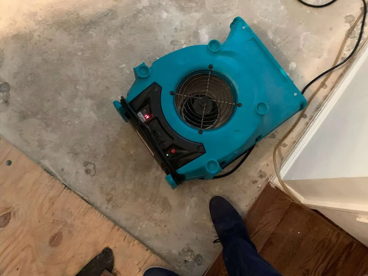 Air mover drying subfloor during Commercial Water Damage Restoration in Sartell